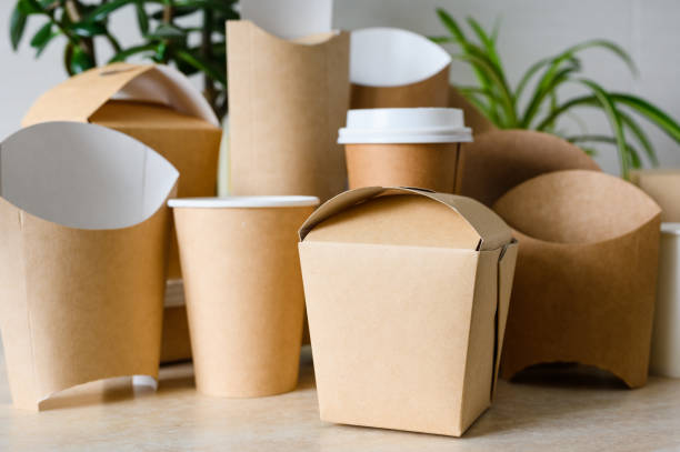 istock Container for noodles on a background of disposable tableware. Disposable tableware and paper packaging. Selective focus on noodle container. 1974385031