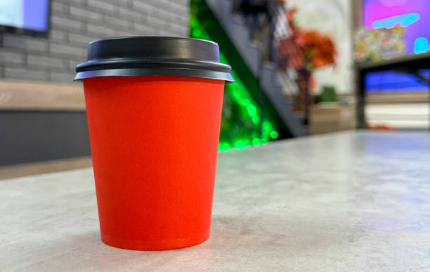 istock Red paper cup for coffee on the table 1974415932