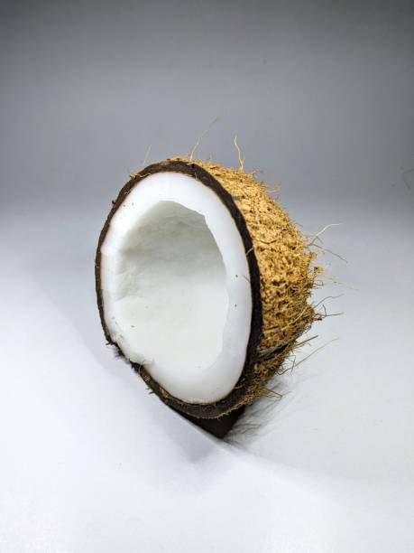 One half of a coconut on a white background