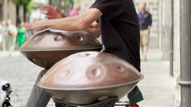 Man playing the handpan (also called hang drum) on the street