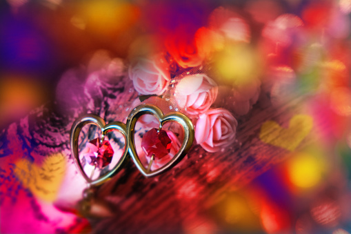 Red crystal hearts and flowers. Soft blurred flares lights. Love, wedding, Birthday, Mothers Day , romance, Anniversary