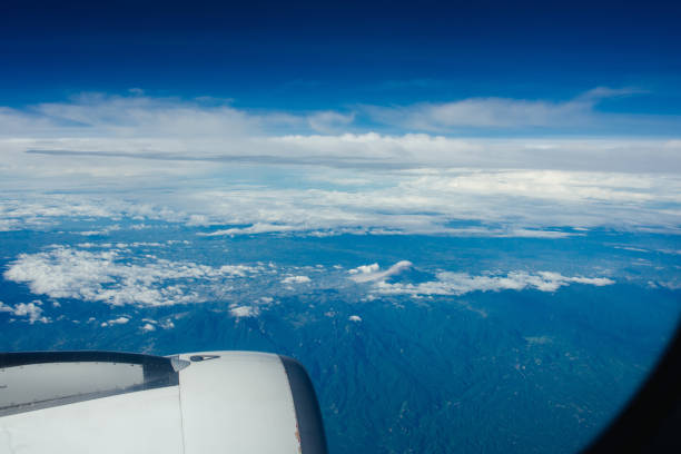 Looking at the engine and sky from the airplane window.
