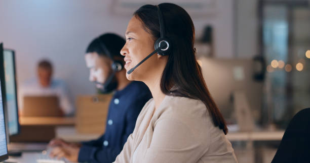 istock Business woman, call center and night communication, customer service or e commerce support on computer. Professional consultant or Asian agent for web solution, questions and happy chat in workspace 1974481148