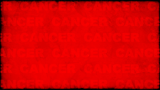 A gradient dark bright vibrant red coloured rustic weathered grunge uneven background with text Cancer all over. Apt for  flyers or posters template with copy space for World Cancer Day.