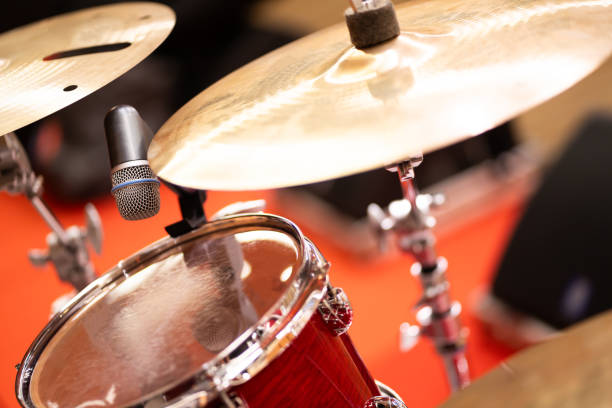 istock Microphone with complete set of red drums in studio music concept 1974523761
