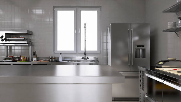 istock Empty clean stainless steel island table in commercial, professional bakery kitchen with convection, deck oven, freezer, refrigerator, shelf, cabinet, equipment in background 1974525875