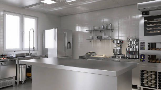 istock Empty clean stainless steel island table in commercial, professional bakery kitchen with convection, deck oven, freezer, refrigerator, shelf, cabinet, equipment in background 1974525876