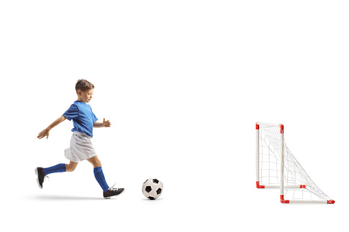 Boy running with a football to score a goal isolated on white background
