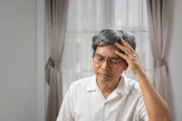 istock Senior asian man suffering from headache at home. 1974540906