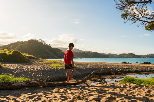 Kids out at beach playing and enjoying themselves in Northland, New Zealand.