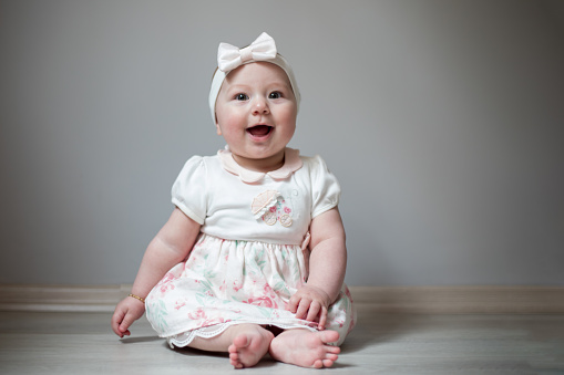 Portrait of a newborn baby lying on a bed in the living room