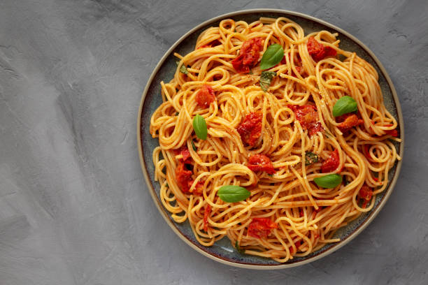 istock Homemade Spaghetti Pasta with Fresh Tomato Sauce on a Plate on a gray surface, top view. Flat lay, overhead, from above. Copy space. 1974578735