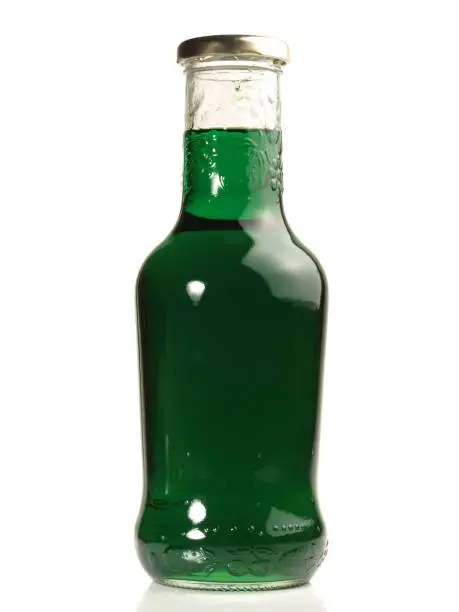 Fresh Woodruff Syrup in a Bottle on white Background