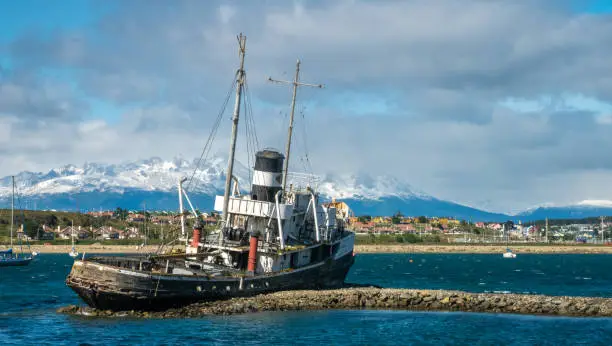 Photo of Old fishing boat wreckage stranded on the shores of the port city of Ushuaia, Tierra del Fuego, Patagonia, Argentina