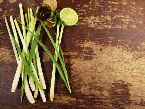 Lemon Grass with Leaves, Lime and Oil on wooden Background