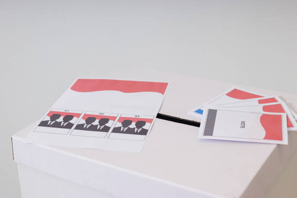 The voting paper of general elections or Pemilu for the president and government of Indonesia on the ballot box. Isolated image on white background stock photo