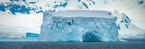 Photo of Gigantic flat top icebers with caves, Paradise Bay, Gerlach Straight, Antarctica