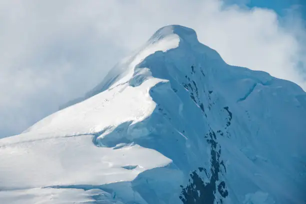 Photo of Stunning summit of one of the mountain peaks of the Antarctic Peninsula, Paradise Bay, Gerlach Straight, Antarctic Peninsula, Antarctica.