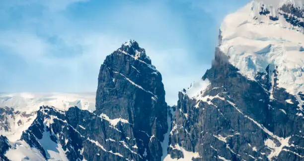 Photo of Unique rock formations on the mountains of the Antarctic Peninsula, an extension of the Andes Cordillera, Antarctic Mainland