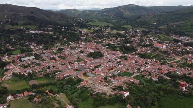 Aerial orbits townscape of picturesque mtn pueblo Samaipata, Bolivia