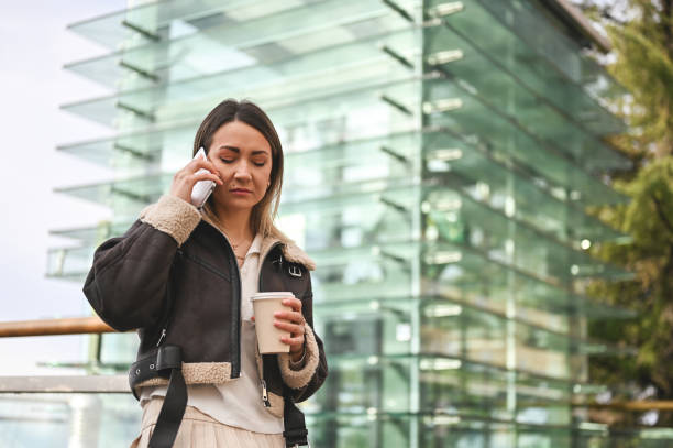 istock Young woman having mobile call outdoors. 1974615606