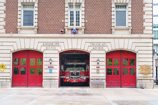 WASHINGTON, USA - 07.04.2023. Fire station in a Washington DC, USA. Fire truck or fire engine in the open garage.