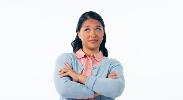 Portrait, woman and frustrated with arms crossed in studio and mockup space, annoyed and moody facial expression or reaction. Asian, person and disappointed emotion or upset face on white background