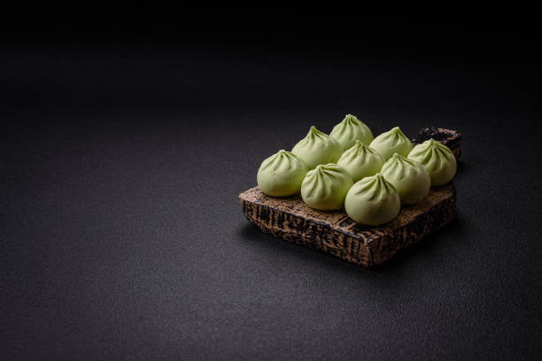 istock Raw khinkali or green dumplings with salt, spices and herbs 1974631151