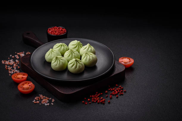 istock Raw khinkali or green dumplings with salt, spices and herbs 1974632213