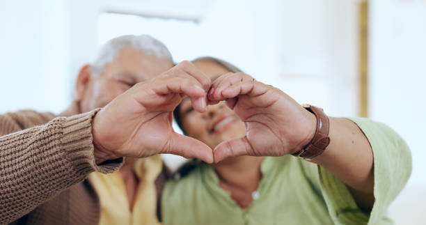 istock Care, heart hands or old couple with support, love or hope in a marriage commitment at home together. Happy, valentines day blur or romantic senior man with smile or elderly woman on anniversary 1974643710