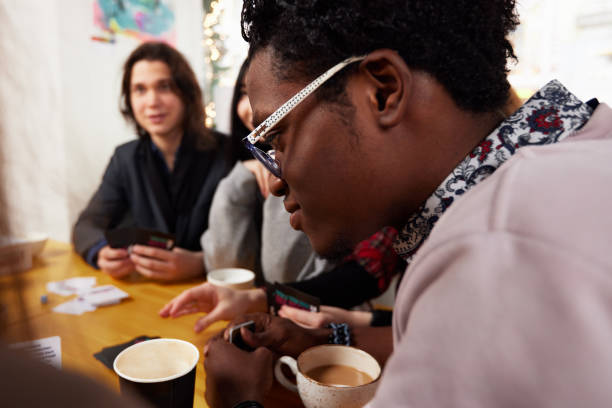 istock Group of multiracial young people sharing ideas and having friendly conversation during coffee break at business meeting in office, panorama 1974646370
