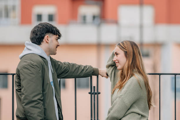 istock couple on the street talking intimately 1974655635