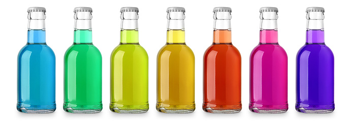 small glass bottles with colored transparent drinks isolated with clipping path