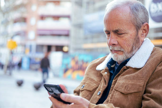 istock Senior man checking cell phone 1974683273