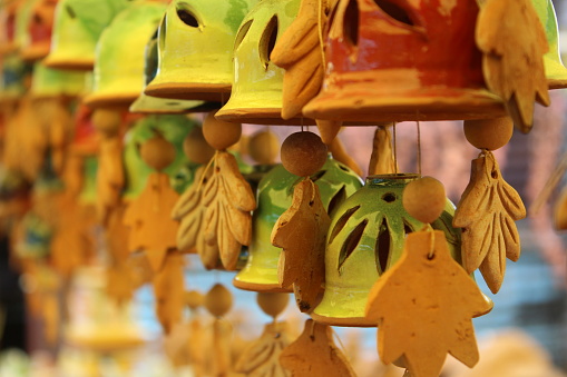 A close-up of decorative bells hanging outside a store