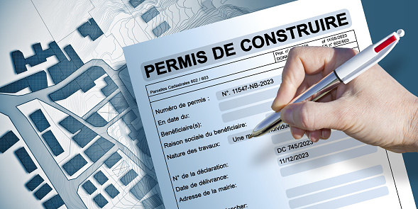 Building permit written in French - PERMIS DE CONSTRUIRE - Building activity and construction industry concept with imaginary Cadastral Map