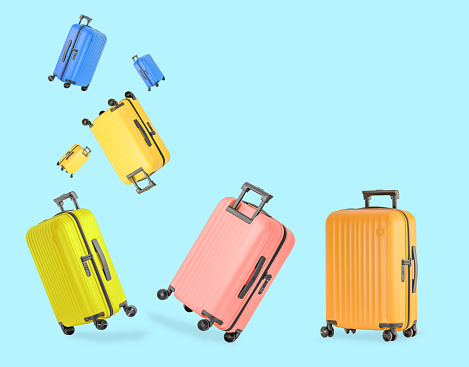 Colorful stylish plastic suitcases for travel with wheels and retractable handle. Travel concept