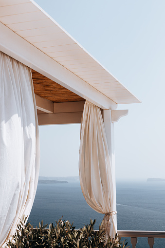 Balcony with curtains and sea view on Santorini island in Imerovigli district, Greece