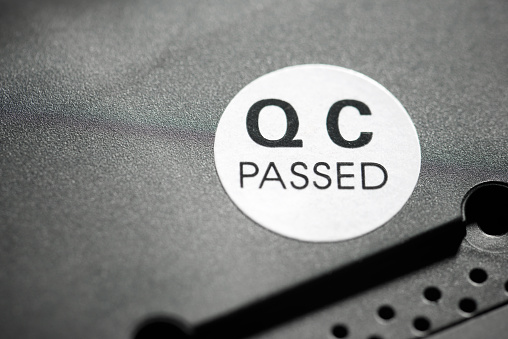 Quality control passed sticker on a black electronic device.