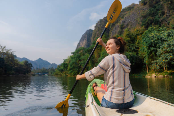 istock Cheerful woman kayaking on river 1974704170
