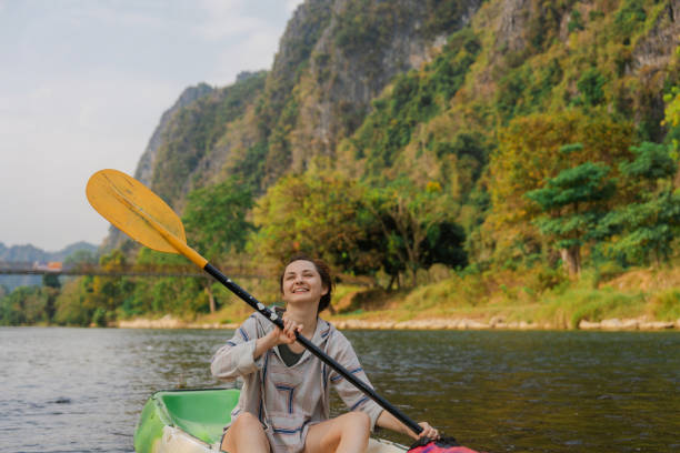 istock Cheerful woman kayaking on river 1974708570
