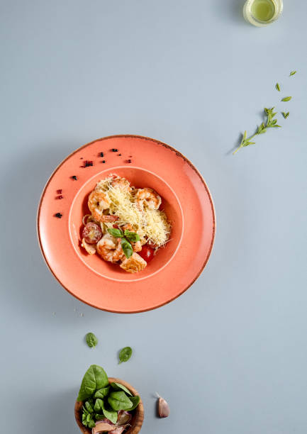 istock Luxurious seafood pasta with tomato and basil, top view with copy space, ideal for gourmet cooking and food styling publications 1974729710