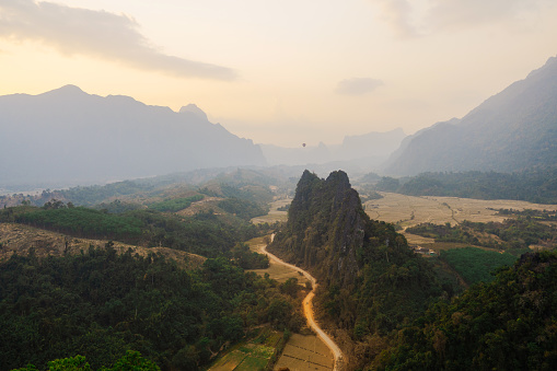 Scenic view of valley with karst mountains at sunset visible from viewpoint