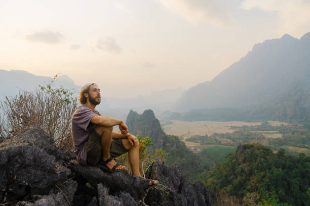 istock Man enjoying view from viewpoint in mountains in Laos 1974737351