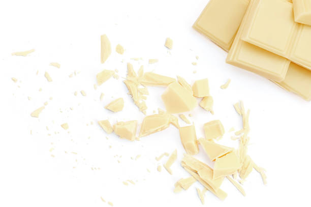 istock White milk chocolate chunks isolated on white background. Chocolate pieces with  crumbs Top view. Flat lay 1974739970