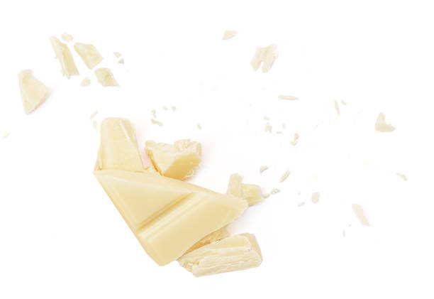 istock  Levitating white milk chocolate chunks isolated on white background. Flying Chocolate pieces explosion, shavings and cocoa crumbs Top view. Flat lay 1974739974