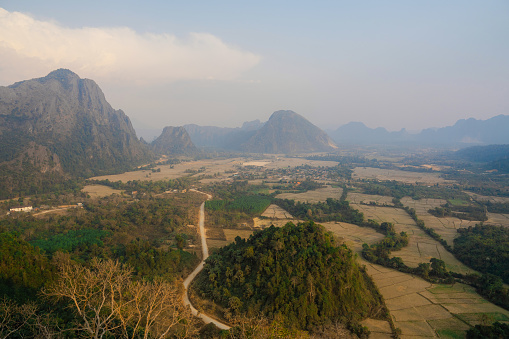 Scenic view of valley with karst mountains at sunset visible from viewpoint