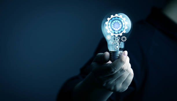istock Creative thinking process. businessman holds a light bulb with gear icon. Meaning of excellent ideas, innovative design 1974768358