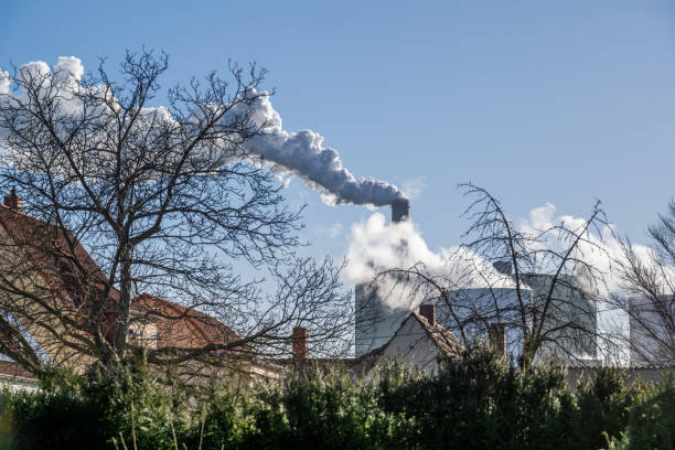 Smoke stacks from factory causing air pollution, landscape shot.