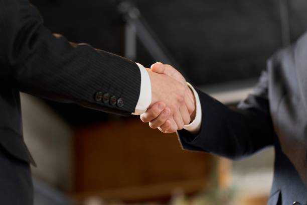 istock Asian business people shaking hands in the office 1974779736